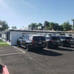 Security vehicles parked in front of office.
