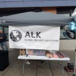 An ALK Global banner at the Trunk or Treat.