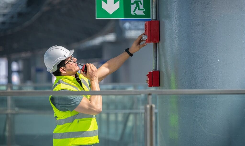 A man working on a fire alarm system