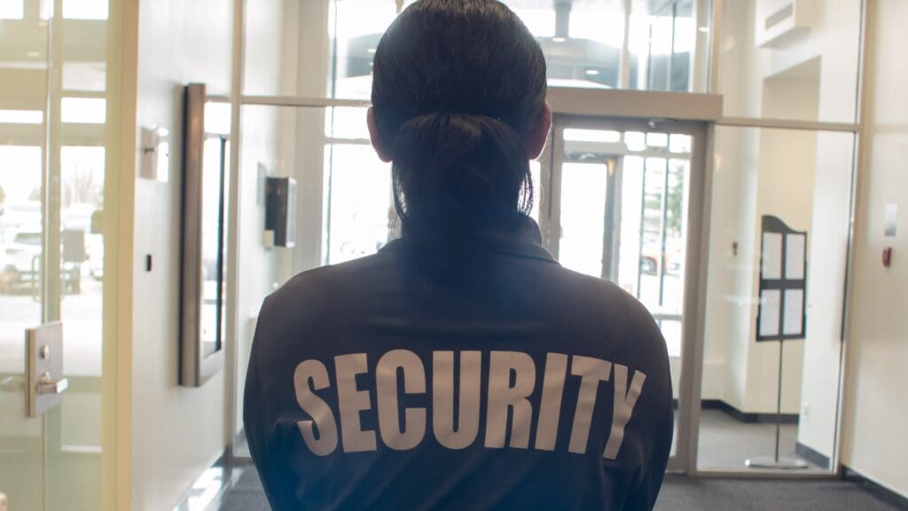 A female security guard patrolling a store entrance