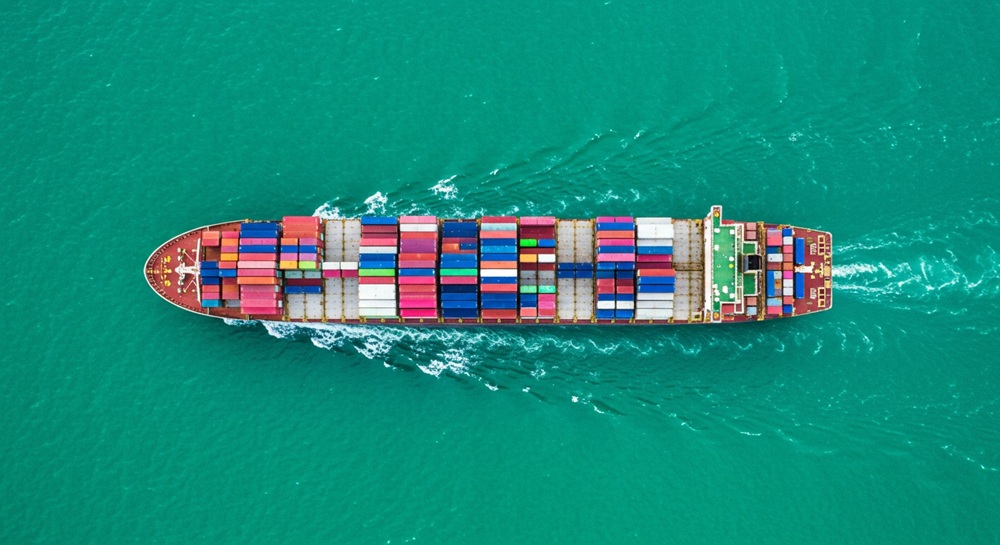 An overhead shot of a cargo ship at sea.