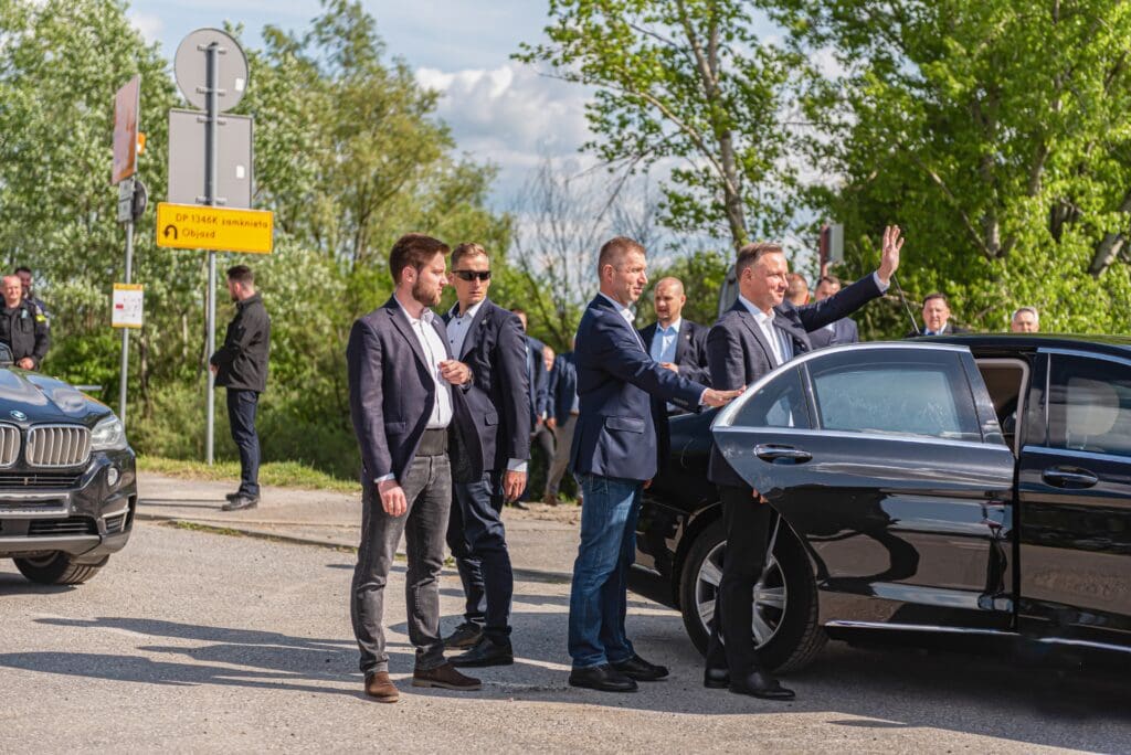 Personal protection agents escorting their client to his vehicle