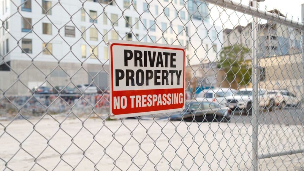 A private property sign on a fence