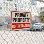 A private property sign on a fence