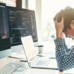 A frustrated businessman with his computer.