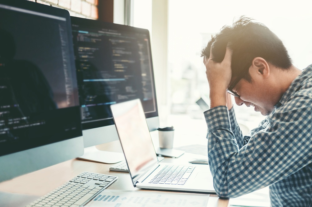 A frustrated businessman with his computer.