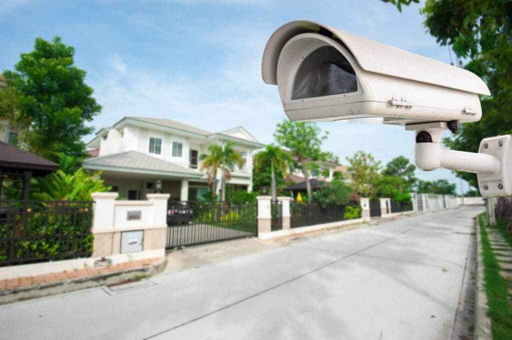 A surveillance camera at the front entrance of a gated community