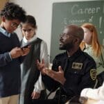 A school security guard talking with young students.
